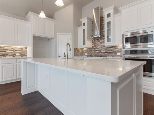 Landon Homes new home builder 515 Sherwood kitchen island and stainless steel appliances white cabinets