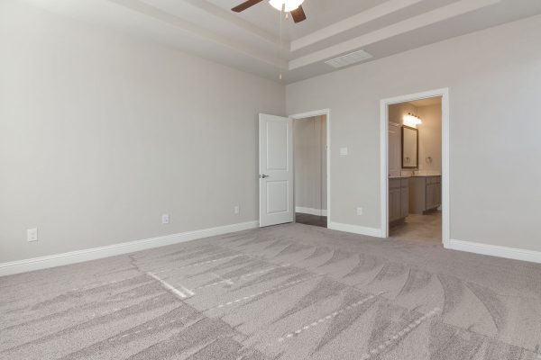 Landon Homes new home builder 515 Sherwood master suite with light tan carpets