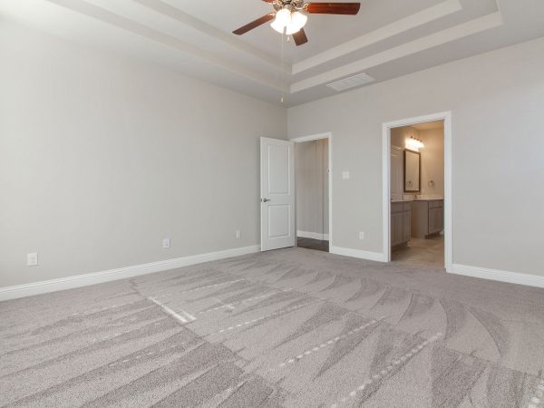 Landon Homes new home builder 515 Sherwood master suite with light tan carpets