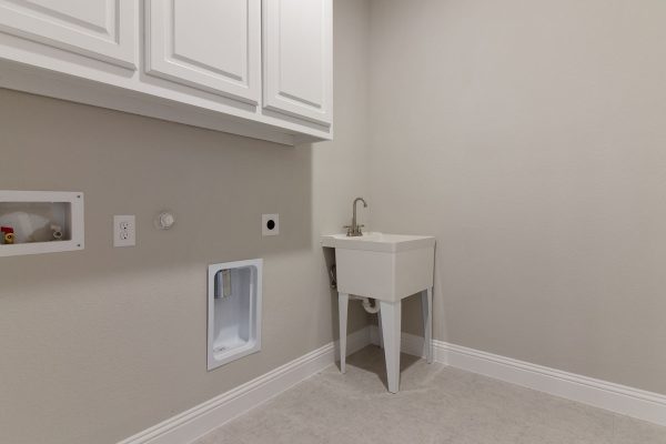 Landon Homes new home builder 515 Sherwood utility room with white cabinets