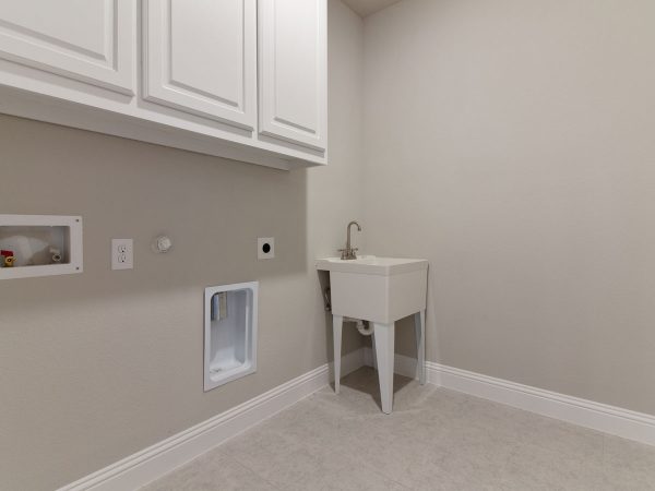 Landon Homes new home builder 515 Sherwood utility room with white cabinets